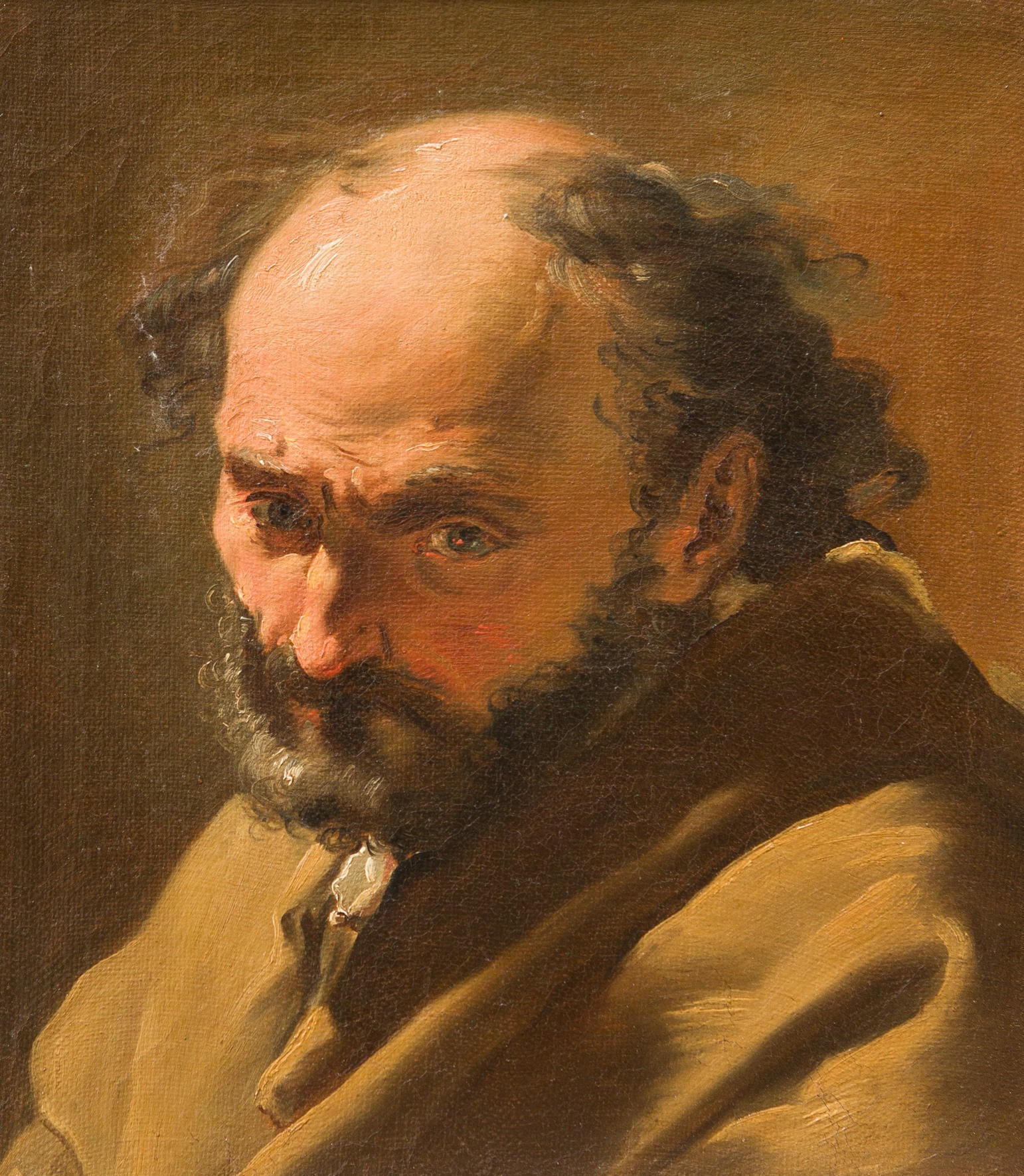 A bearded man, bust length, in a grey cape